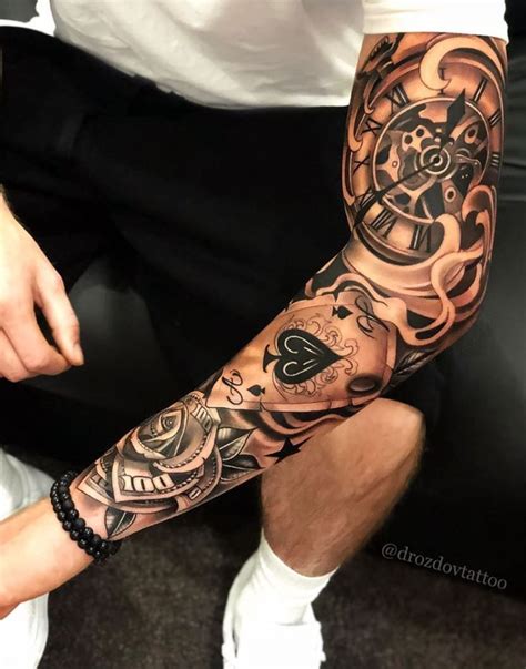A Man Sitting Down With A Tattoo On His Arm
