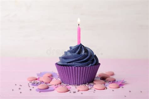 Delicious Birthday Cupcake With Cream And Candle On Pink Table Stock