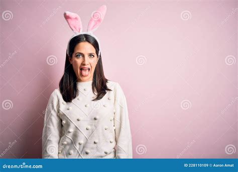 Young Caucasian Woman Wearing Cute Easter Rabbit Ears Over Pink