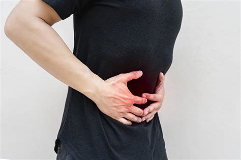Young Man Holding His Stomach In Pain Stock Photo Download Image Now