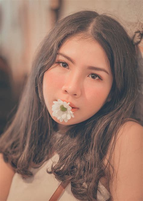 Free Photo Woman Having A White Daisy On Her Mouth Blure Cheerful Face Free Download Jooinn