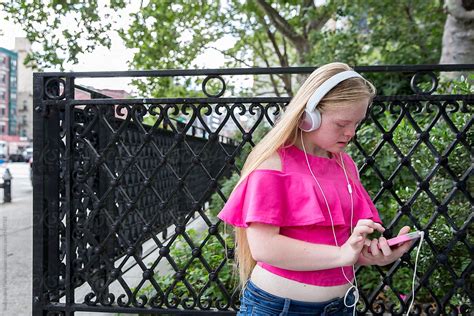 Girl With Down Syndrome Listening To Music By Stocksy Contributor