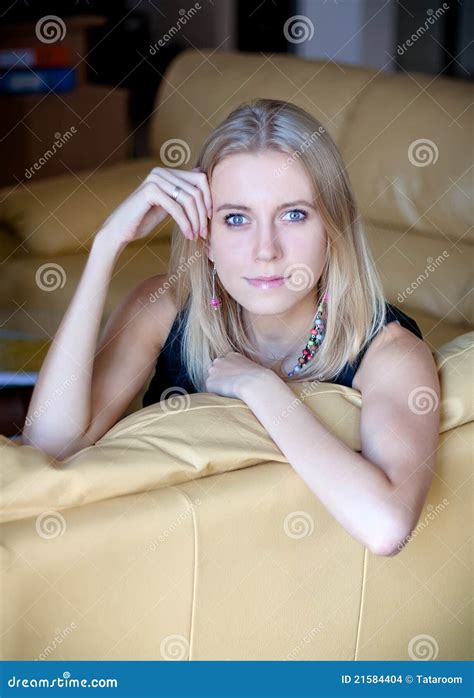 Young Blond Lady Seating On The Leather Sofa Stock Photo Image Of