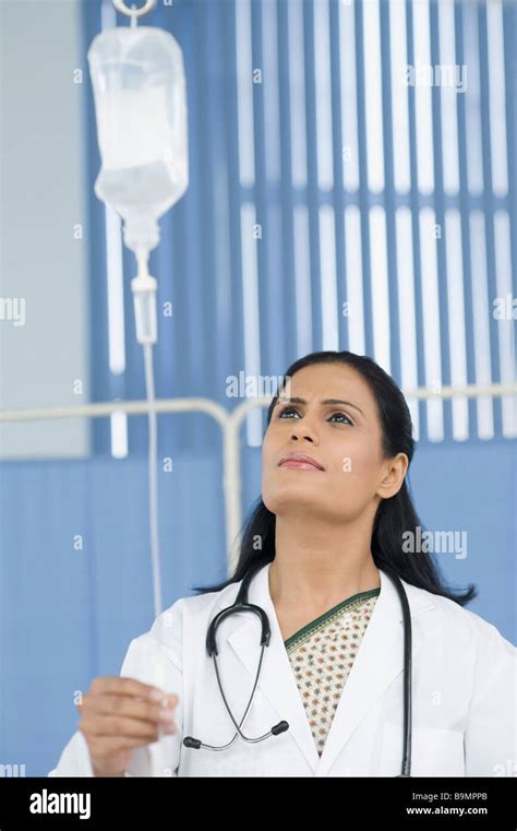Female Doctor Adjusting An Iv Drip Stock Photo Alamy