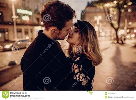 Stylish Gypsy Couple In Love Hugging And Kissing In Evening City Stock