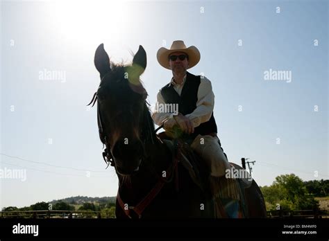 Cowboy Riding His Horse With The Sky In The Background Stock Photo Alamy