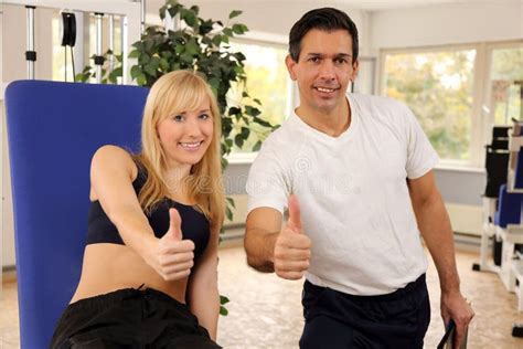 Attractive Blonde Woman And Her Trainer In A Gym Stock Image Image Of