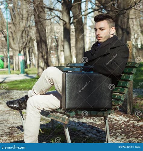 Portrait Of A Handsome Young Man Sitting On A Bench Stock Image Image