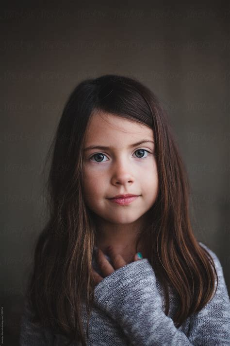 Portrait Of A Young Girl With Her Hand Over Her Heart By Stocksy Contributor Amanda Worrall