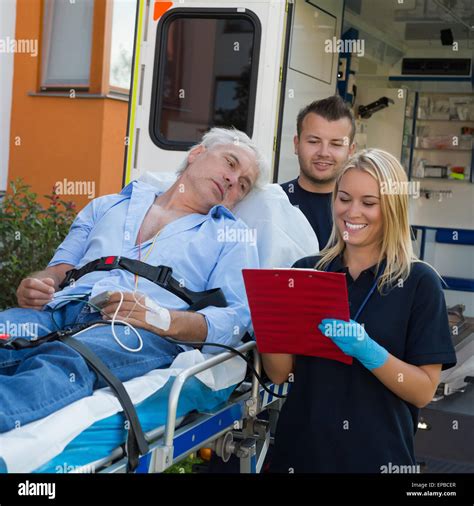 Emergency Team Treating Patient On Stretcher Stock Photo Alamy