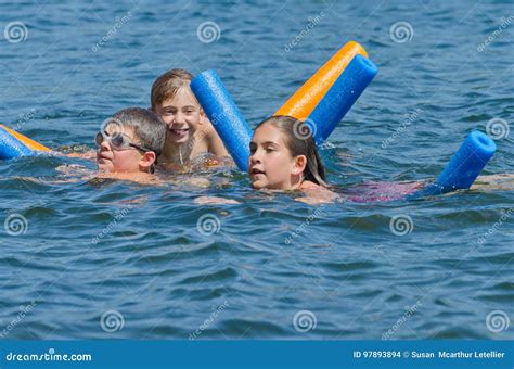 Kids Having Summer Fun Swimming In Lake Stock Photo Image Of Jump