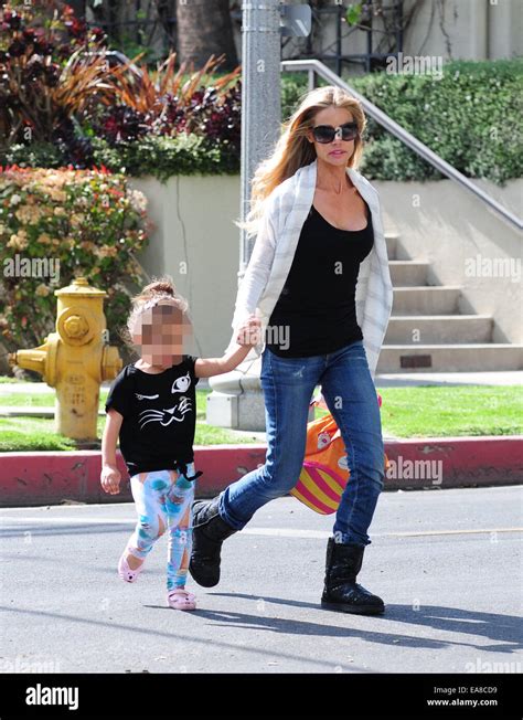 Denise Richards Walking In Ugg Boots And Jeans Carries Her Daughter