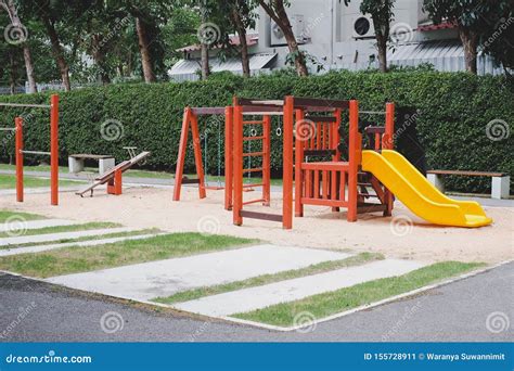 Children Playground On Yard Activities In Public Park Surrounded By