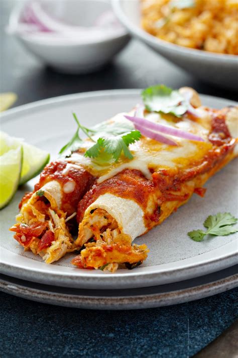 Roll enchiladas up then transfer to prepared baking dish (fitting 7 per dish). Red Chicken Enchiladas - Oh Sweet Basil