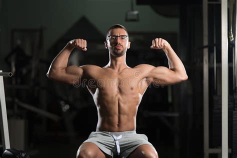Muscular Geek Man Flexing Muscles In Gym Stock Photo Image Of Human