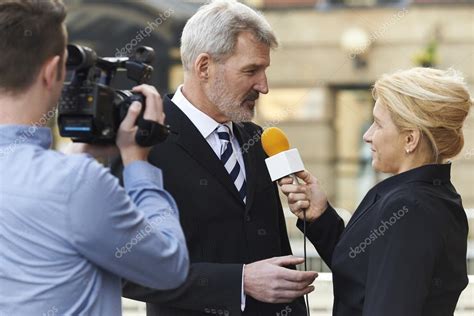 Female Journalist With Microphone Interviewing Businessman — Stock