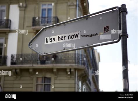 Kiss Her Now Graffiti On The Rear Of A Street Sign Geneva Switzerland