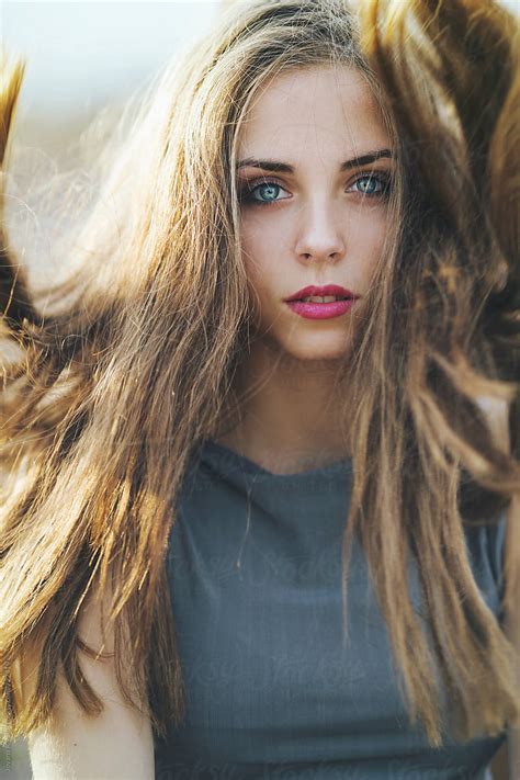 Beautiful Young Woman With Blue Eyes With Wind In Hair By Stocksy