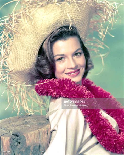 American Actress Angie Dickinson Wearing A Pink Garland And A Straw