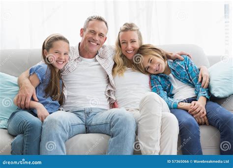 Parents And Children Sitting Together On Couch Stock Photo Image Of