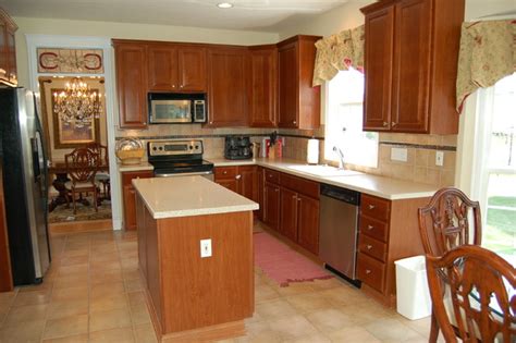 We moved into our house 6 months ago and i really don't like the cherry cabinets, backsplash and black granite countertops in our kitchen. Traditional Kitchen with Dark Cherry Cabinets ...