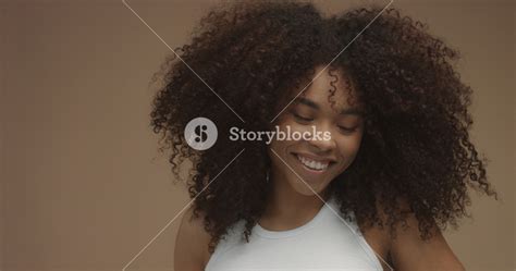 Mixed Race Black Woman Portrait With Big Afro Hair Curly Hair In Beige