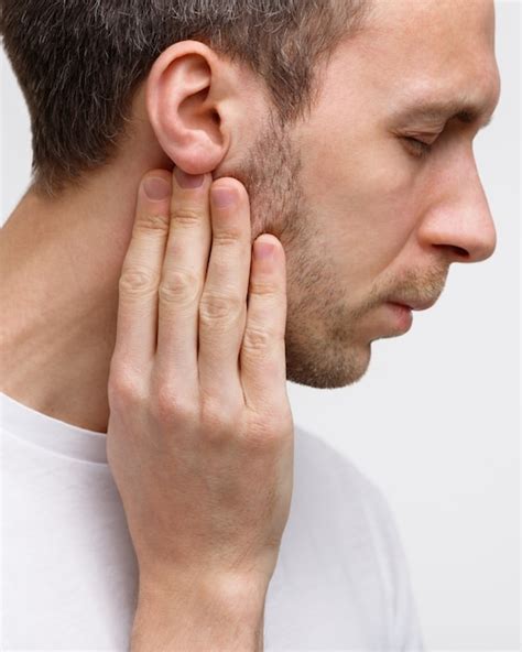 Premium Photo Man Touches The Lymph Glands With His Fingers Near The Ear