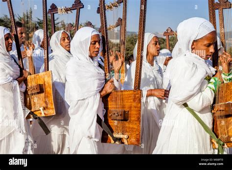 A Procession Of Female Ethiopian Christians Carrying Begenas Arrive At