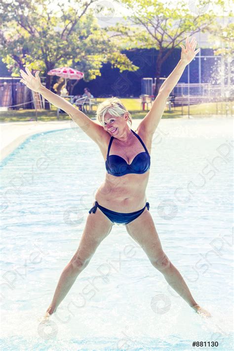 Beautiful Mature Woman In Swimsuit Makes Gymnastics Stock Photo