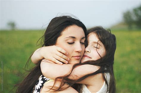 Happy Sisters Hugging Together Outdoors By Jovana Rikalo Stocksy United