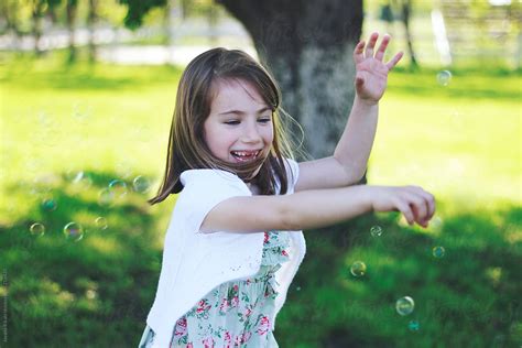Little Girl Catching Bubbles By Stocksy Contributor Jovana Rikalo