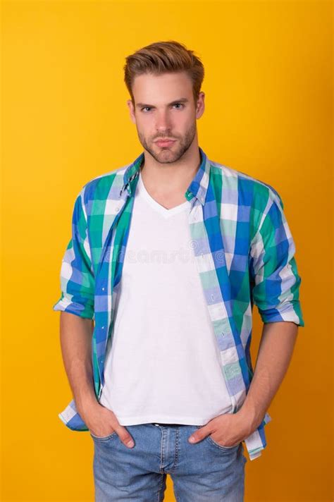 Handsome Caucasian Guy Pose In Checked Shirt Keeping Hands In Pockets