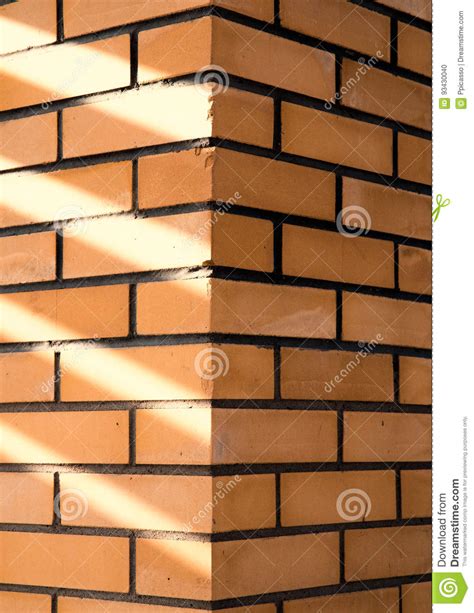 Texture Of A Corner Of A Brick Wall With Rays Of Sunlight Stock Photo