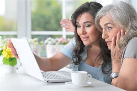 Portrait Of Two Mature Women Using Laptop Stock Photo Image Of Female Indoors