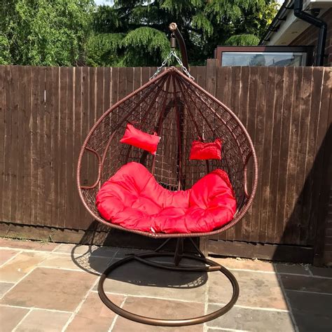 It's an online exclusive you don't want to miss. Double Outdoor Rattan Hanging Egg Chair- Red Cushions - Nitaar