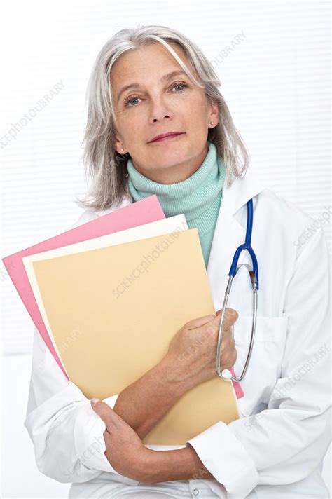 Mature Female Doctor Holding Files Stock Image F0117698 Science Photo Library