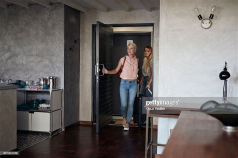 Two Young Woman Arriving To Urban Rental Apartment Photo Getty Images