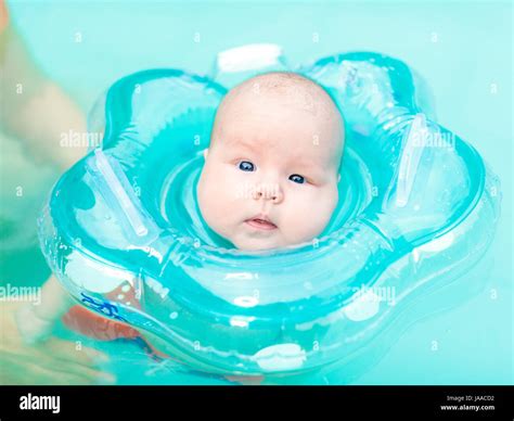 Baby Swimming With Neck Swim Ring In Pool Stock Photo Alamy