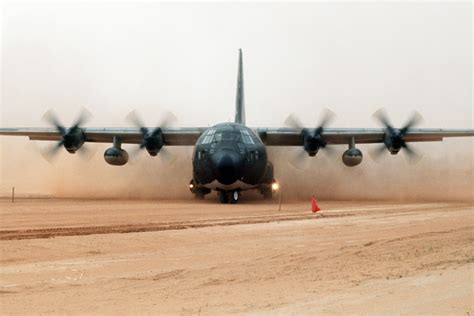 A C 130 Hercules Aircraft Is Enveloped In Dust As It Performs An