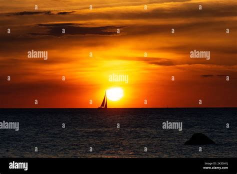 Beautiful Orange Sunset Over The Sea A Ship On The Horizon Stock Photo