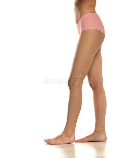 Side View Of Pretty Female Bare Legs In Pink Panties Standing On White
