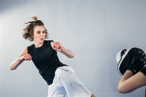 Female Martial Arts Fighter Practicing With Trainer Punching Taekwondo