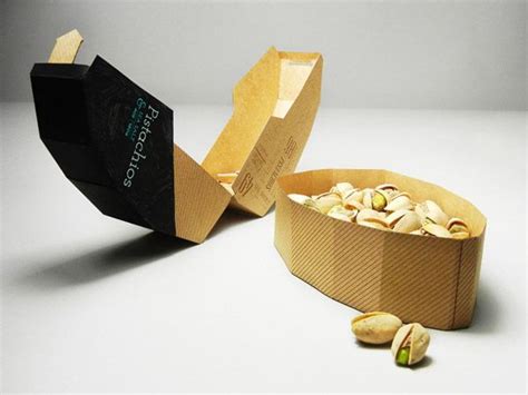 An Open Box Filled With Nuts Sitting On Top Of A White Table Next To It