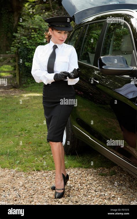 Woman Chauffeur Putting On Her Uniform Black Leather Gloves Stock Photo