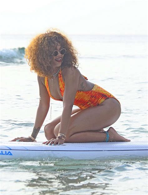 Rihanna Wears Flame Coloured Swimsuit While Paddleboarding In Barbados