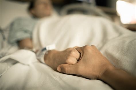 Man Holding Woman Hand In Hospital Bed Holding Hands In Hospital Bed Stock Photo - Download ...