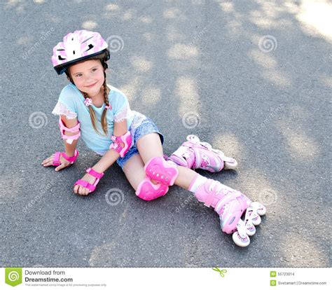 Cute Smiling Little Girl In Pink Roller Skates Stock Photo