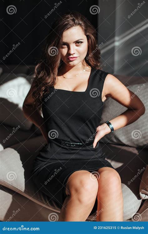 Portrait Of A Brunette In A Black Dress On A Dark Background Girl Takes Stock Image Image Of