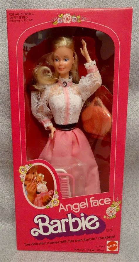 A Barbie Doll In A Pink Box With White Lace On It S Collar And Sleeves
