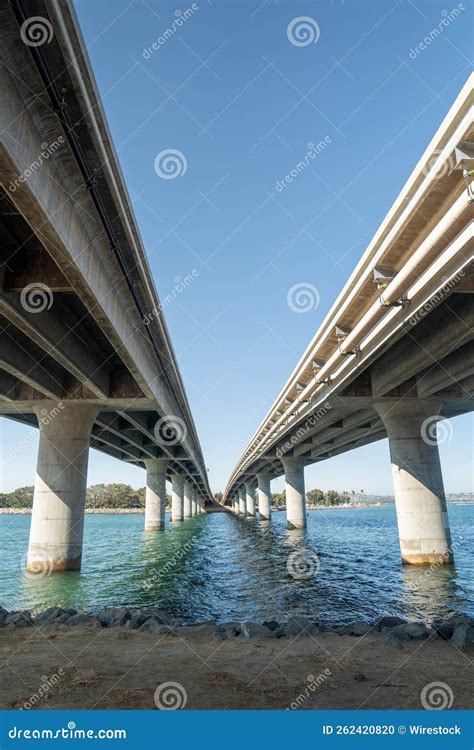 Parallel Bridges Over A River Under A Clear Blue Sky Stock Photo